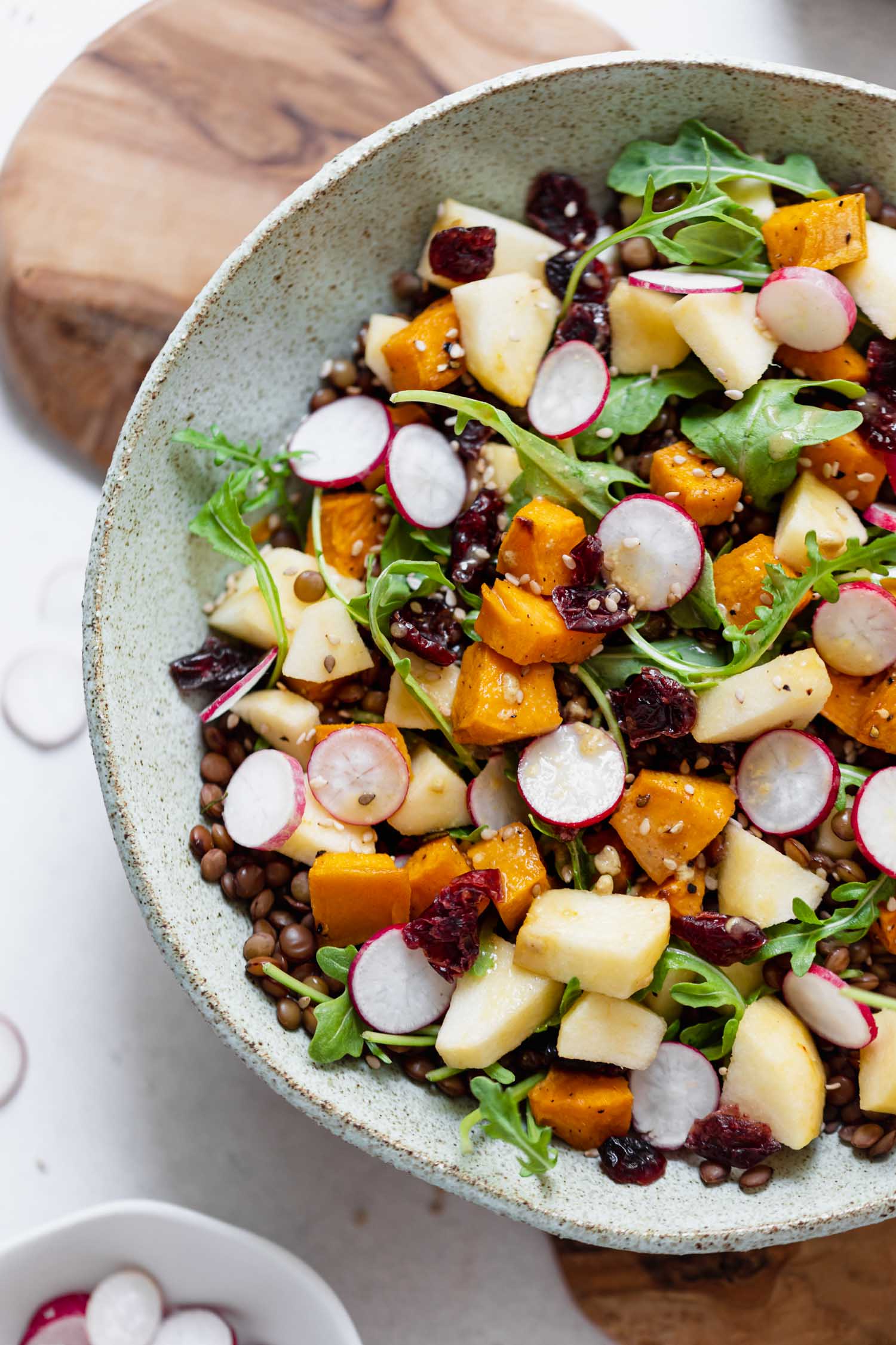 Salade de lentilles, patate douce rôtie, pomme et cranberries, sauce à l'orange